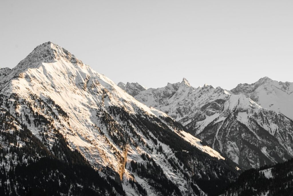 Snow-covered alpine mountains at winter golden hour
