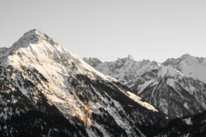 Snow-covered alpine mountains at winter golden hour